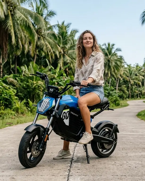 Woman riding electric bike on jungle road, Siargao
